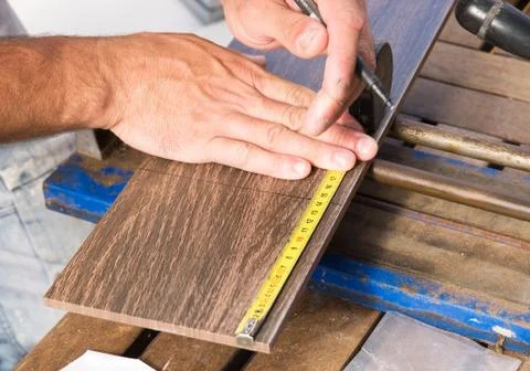 Man measuring a tile piece Stock Photos