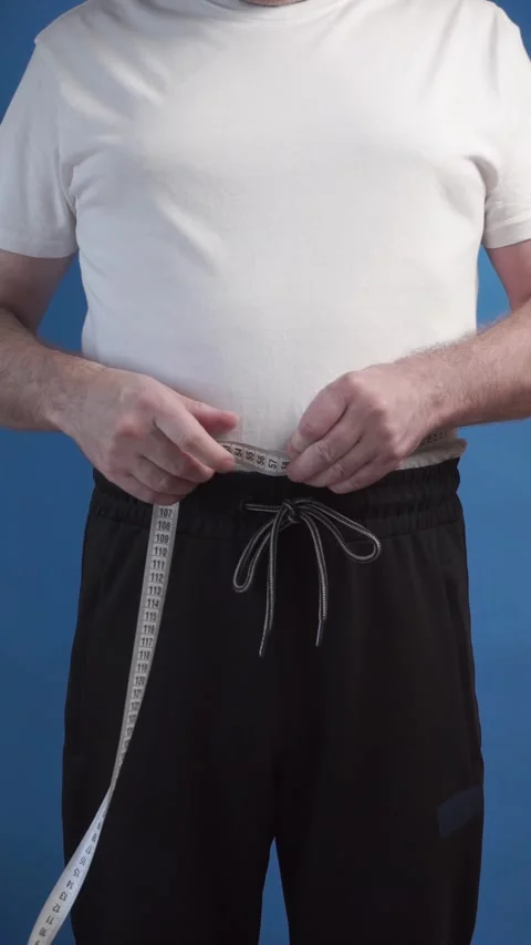 Man measuring waist Stock Footage 283544088