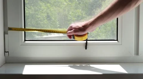 Man measuring a window with yellow centimeter Stock Footage 64621528