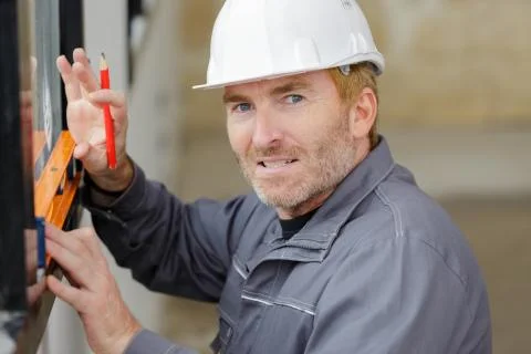A man is measuring windows Stock Photos