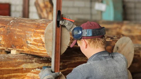 Man measuring a wooden post on the level Stock Footage 65314986