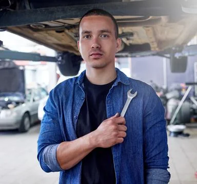 Man, mechanic and tool in engineering for auto repairs, handyman or service at Stock Photos