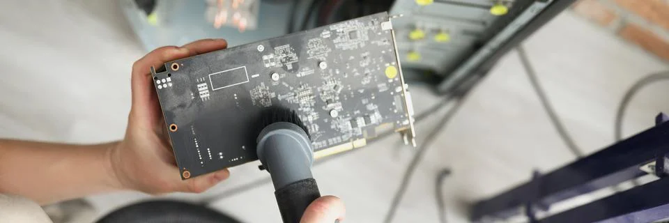 Man mechanic clean computer processor detail with vacuum cleaner nozzle Stock Photos