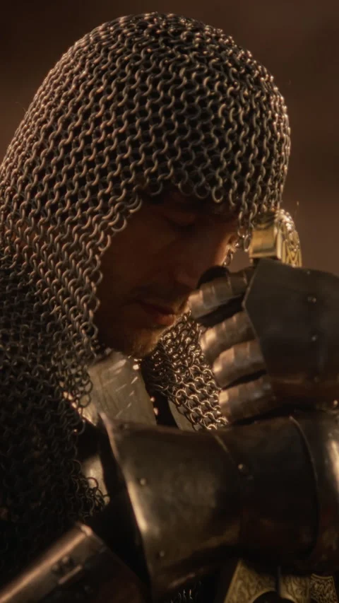 Man in Medieval Armor Praying with Sword before Battle Stock Footage 345518991