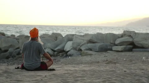 Man meditates on Beach Medium Wide Stock-Footage 67638328