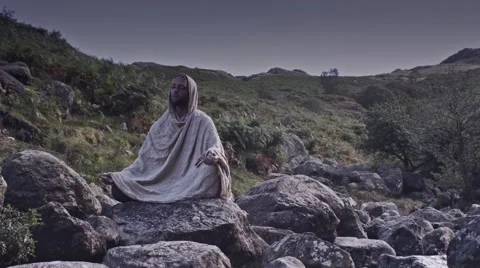 Man meditates on rocks timelapse front view Stock Footage 41843519