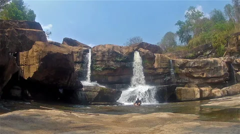 Man meditates in a waterfall Stock Footage 50005991
