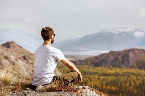 Man meditating in the mountains Stock Photos
