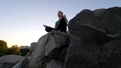 Man meditating in nature Stock Footage 82063149