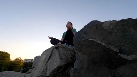 Man meditating in nature Stock Footage 82063159