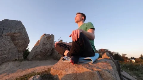 Man meditating in nature Stock Footage 82063199