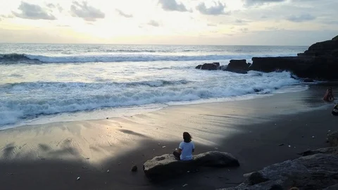 Man Meditating at the Ocean at Sunset on a Beach in Bali Indonesia Video stock 101790463