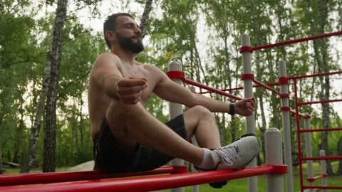 Man Meditating on Parallel Bars at Outdoor Gym Stock-Footage 330044287
