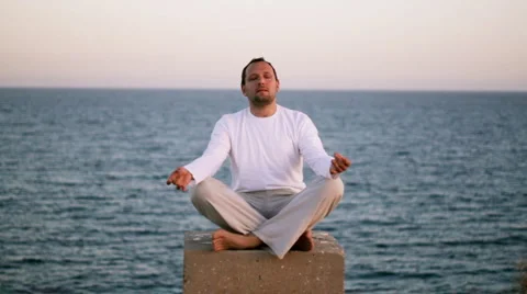 Man meditating by the sea  스톡 동영상 1063436