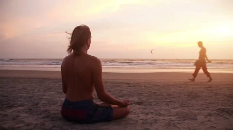 Man meditating at sunset Stock Footage 52633298