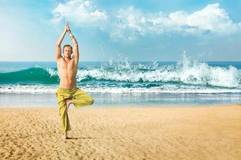 Man meditating in tree position Stock Photos