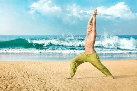 Man meditating in warrior pose Stock Photos