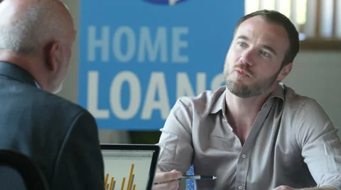 Man meeting with a banker for a home loan Stock Footage