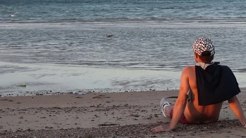 Man meets a sunset on the beach Stock Footage 69860706