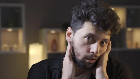 A man with a mental illness looks at the camera. Crazy man. Stockbeeldmateriaal 222483481