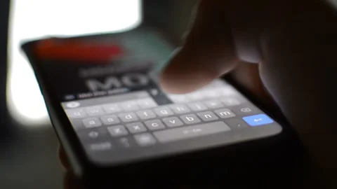 Man message on phone. type a message on the iphone device. Video stock 237437080