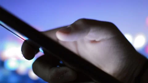 Man messaging on his iphone in a night city background. phone message. Stock-Footage 217439878
