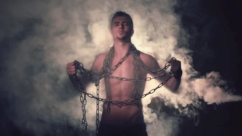 Man in metal chains in smoke. Vídeos de archivo 80848771