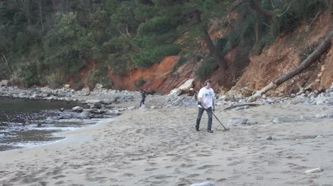 Man with metal detector on the beach Stock Footage 45888895