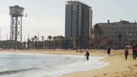 A man with a metal detector is looking for valuable things on the beach Stock Footage 101269511