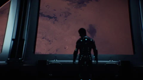 Man in a metal space suit doing something in the control room with Mars view Stock-Footage 240365725
