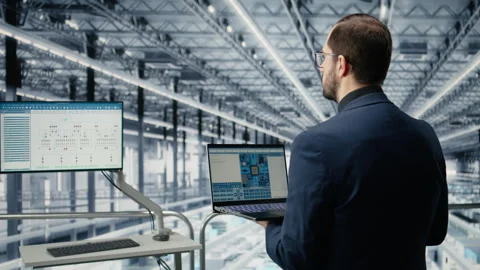 Man in microchip smart factory using MES software simulation app Stock Footage 333379635