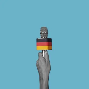 Man with a microphone patterned with the german flag Stock Photos