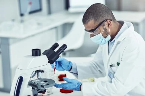 Man, microscope and science at lab with blood sample, test and research for mpox Stock Photos