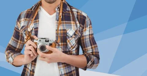 Man mid section with camera against blue vector mesh Stock Photos