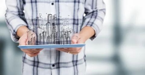 Man mid section with tablet and sketch of building against blurry grey room Fotos de archivo