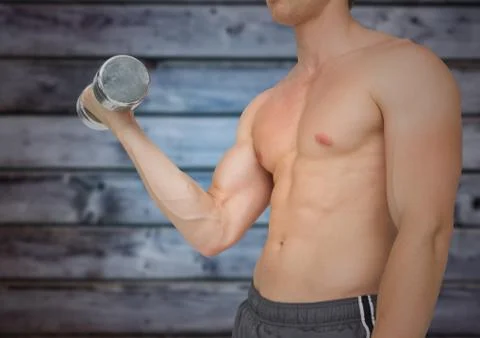 Man mid section weightlifting against blurry blue wood panel Stock Photos