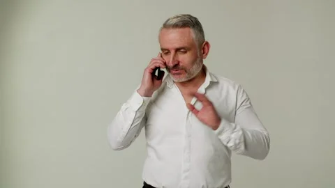 A man middle aged boss uses smartphone, communicates with subordinate in Stock Footage 252880560