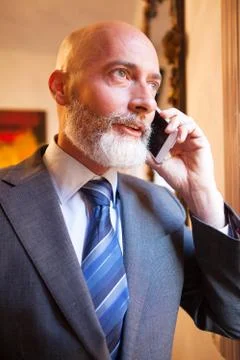 Man middle-aged talking on his smartphone Stock Photos