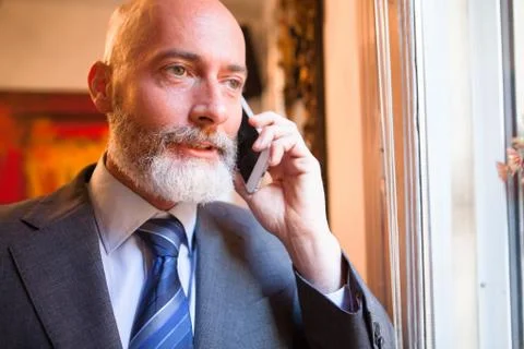 Man middle-aged talking on his smartphone Stock Photos