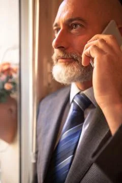 Man middle-aged talking on his smartphone Stock Photos