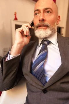 Man middle-aged talking on his smartphone Stock Photos