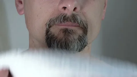 Man of middle ages with a beard and mustache wipes his face with a towel,closeup Stock Footage 135882757