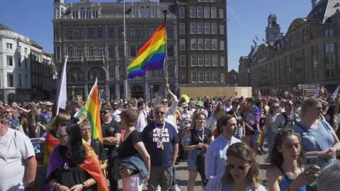 Man middle of Crowd with Rainbow Flag Lhbti+ Gay Pride Netherlands Amsterdam Stock Footage 234409349