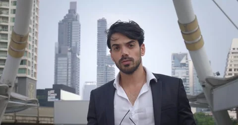 Man Middle Eastern appearance in suit on busy street metropolis takes off Stock Footage 312500312