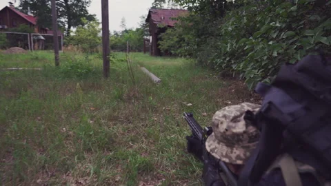 Man in military uniform aiming while lying down Stock Footage 245798238