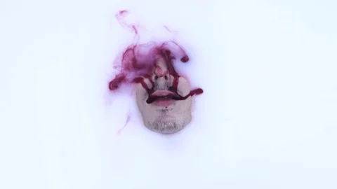 Man in milk bath and blood flows from his mouth Stock Footage