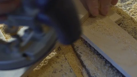 A man mills woodworker in a woodworking workshop, a carpenter in a respirator Stock Footage 107614331