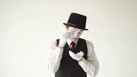 Man mime standing on white background and crying bitter tears Stock Footage 73376807