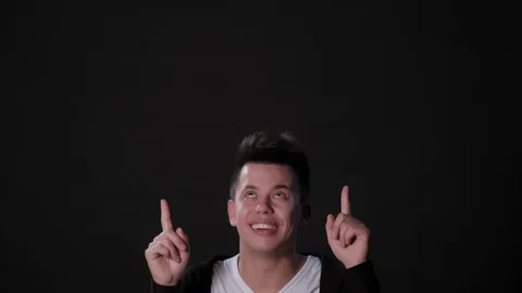 A Man Mimicing Against a Black Background Stock Footage 87308860
