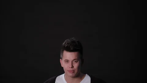 A Man Mimicing Against a Black Background Stock Footage 87309215